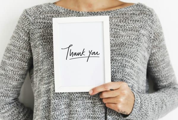 Woman holding a Thank You card